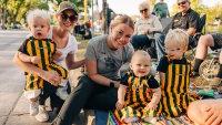 Kids wearing striped overalls while waiting for Homecoming parade festivities